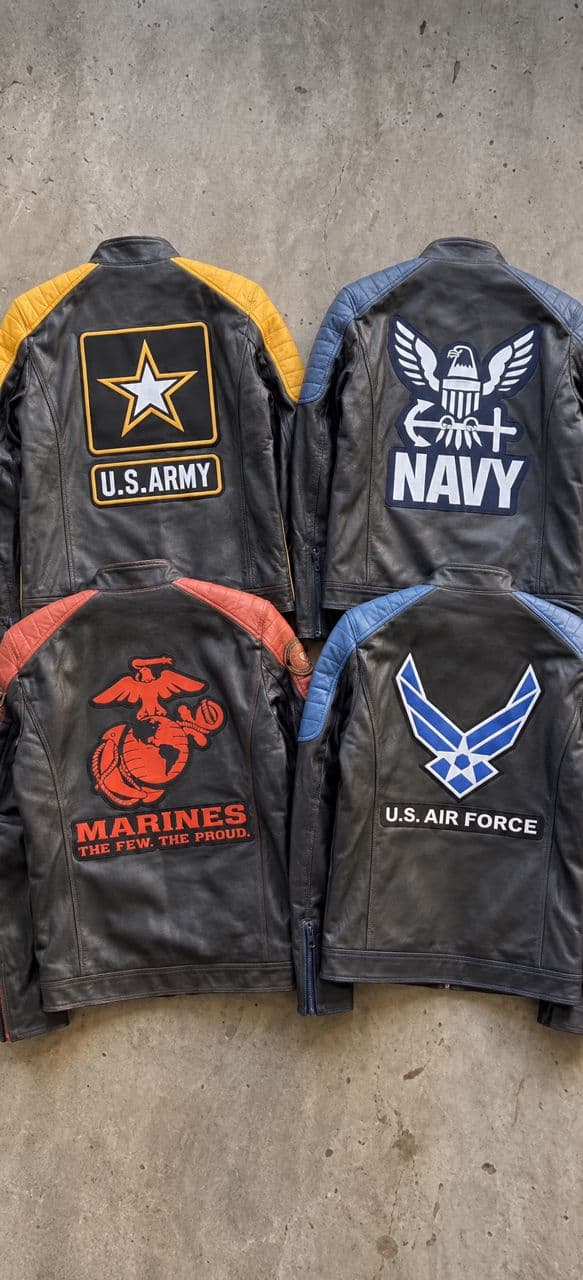 Four racer jackets showing Army, Navy, Marines, and Air Force back emblem options